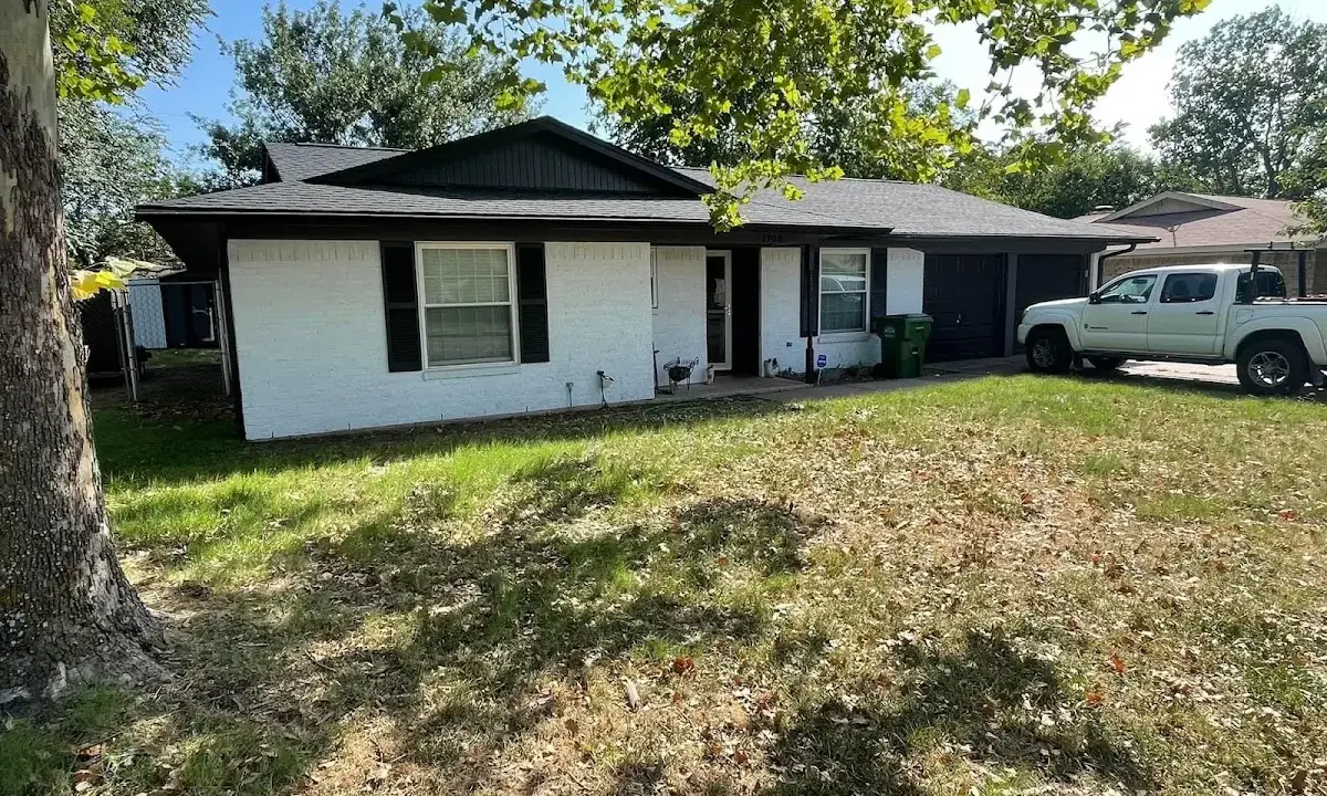 Professional roofing crew working on a residential roof in Piqua